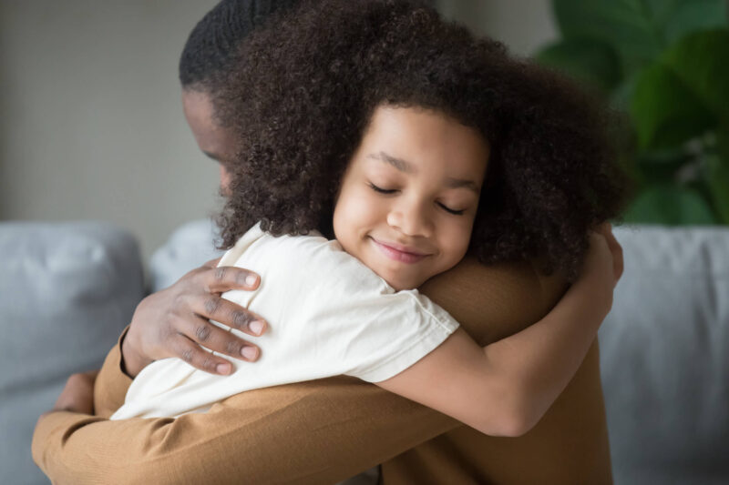 foster parent and child hugging