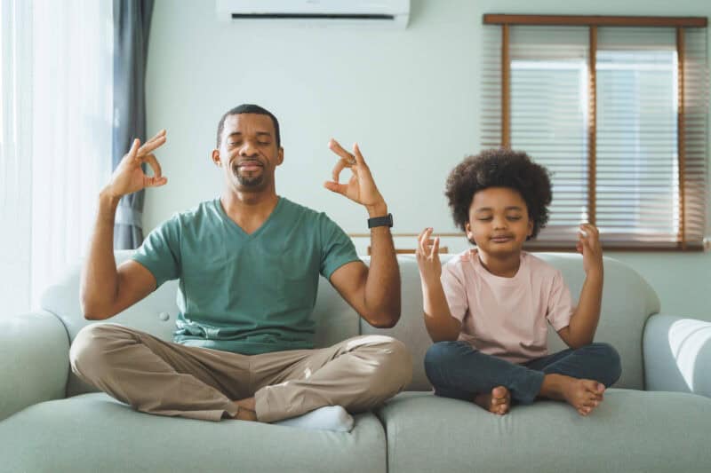 foster parent and child meditation on couch